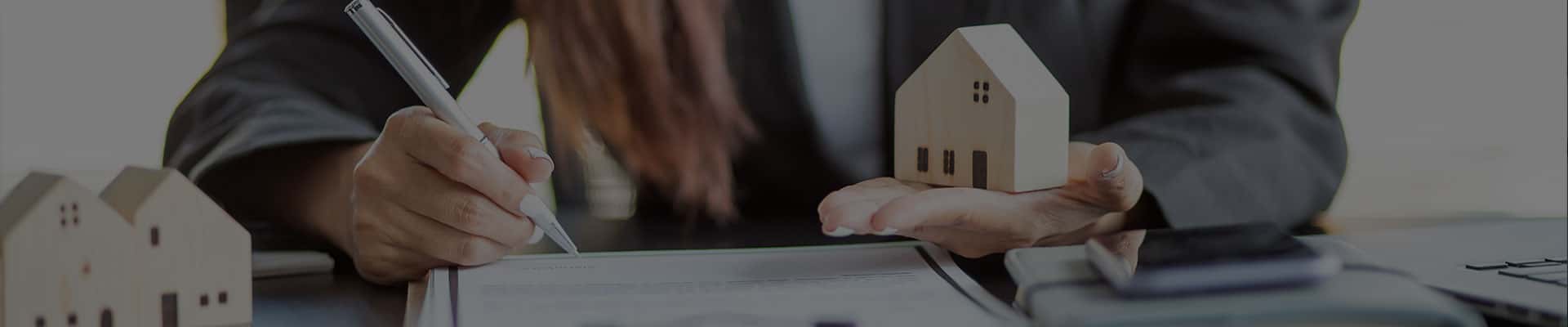 woman holding toy house